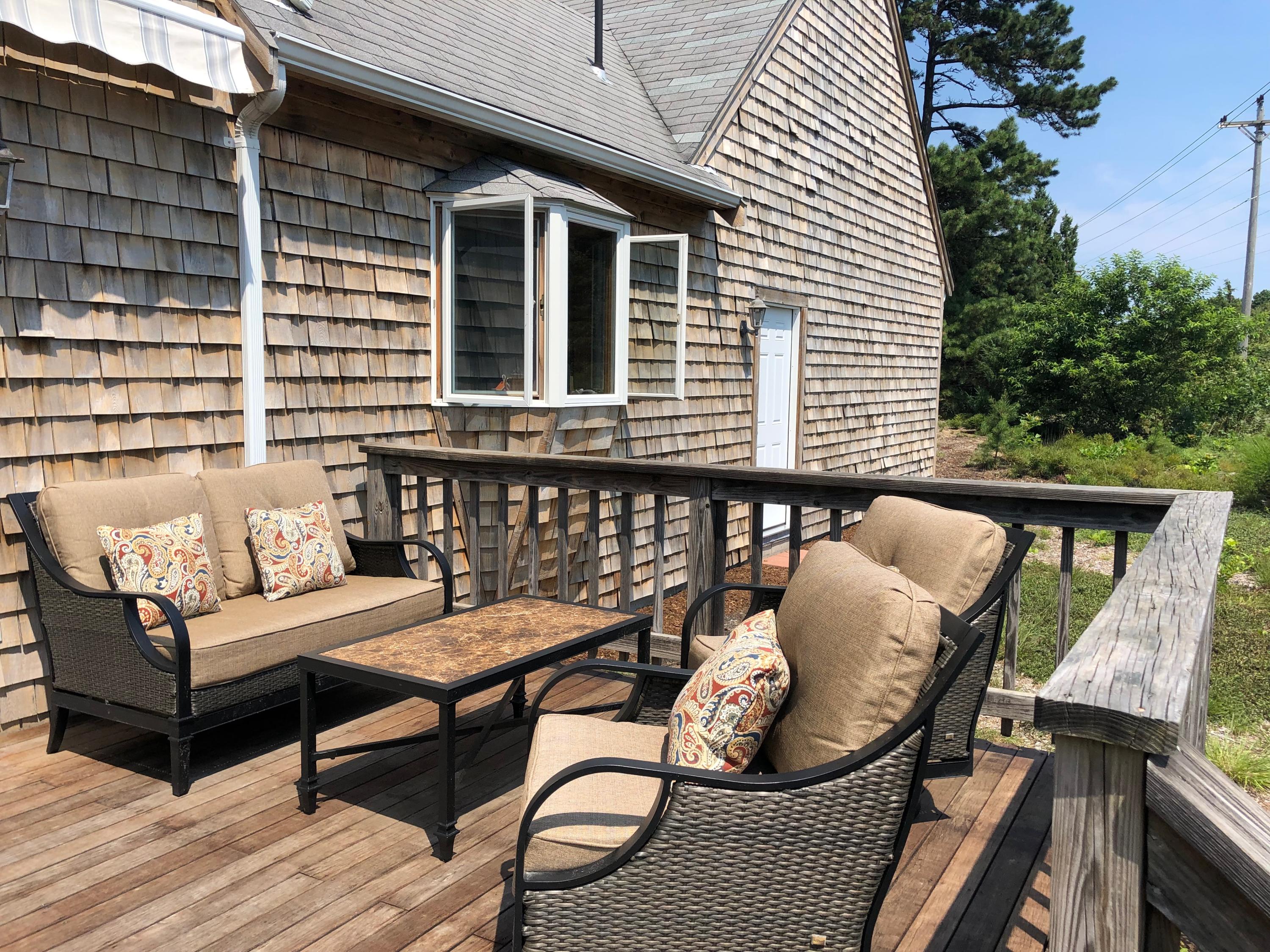 90 Jennie Clark Road Eastham, MA 02642 - Photo 13 of 35 a balcony with furniture and wooden floor