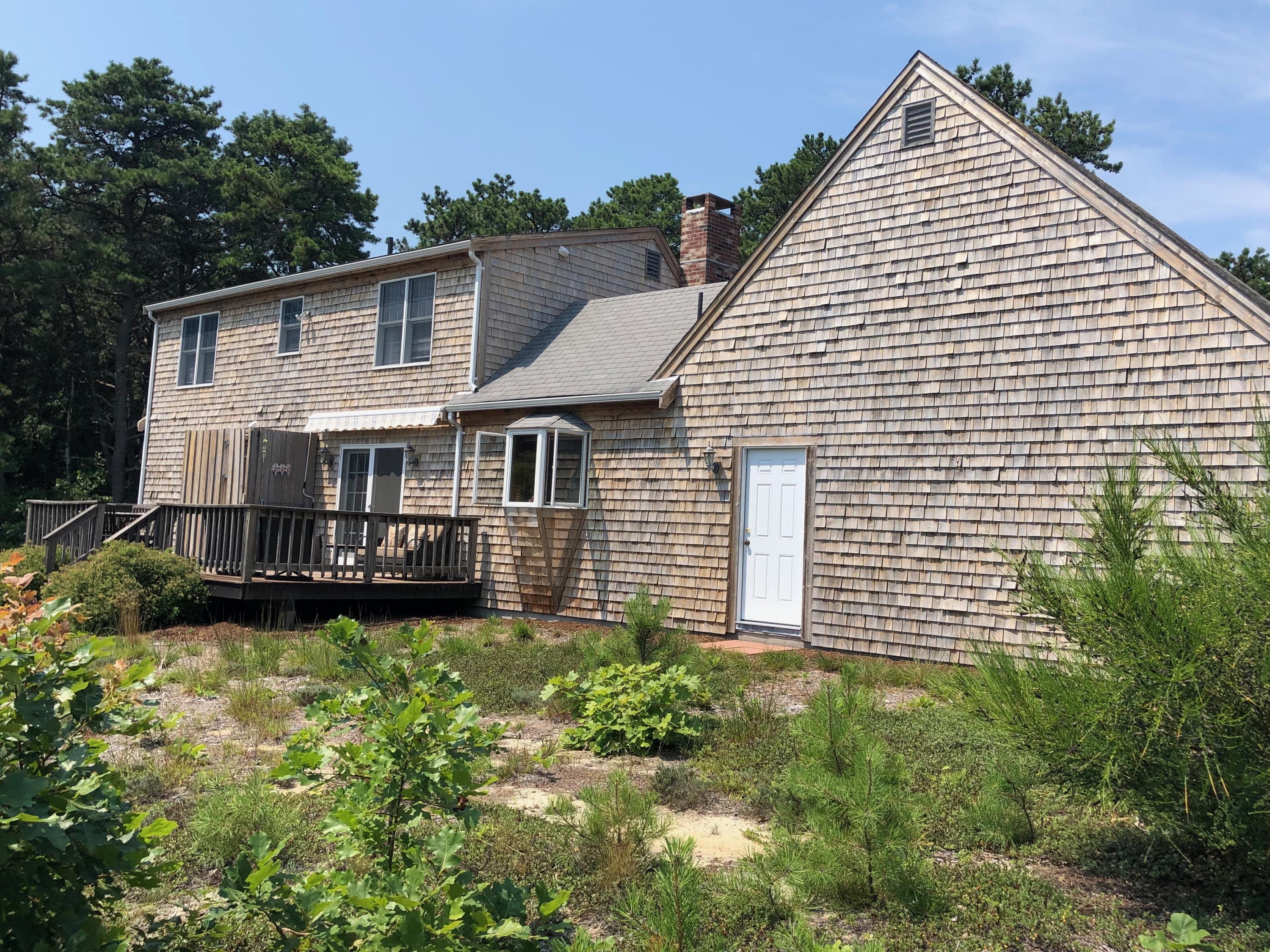 90 Jennie Clark Road Eastham, MA 02642 - Photo 27 of 35 a view of a house with a yard and sitting area