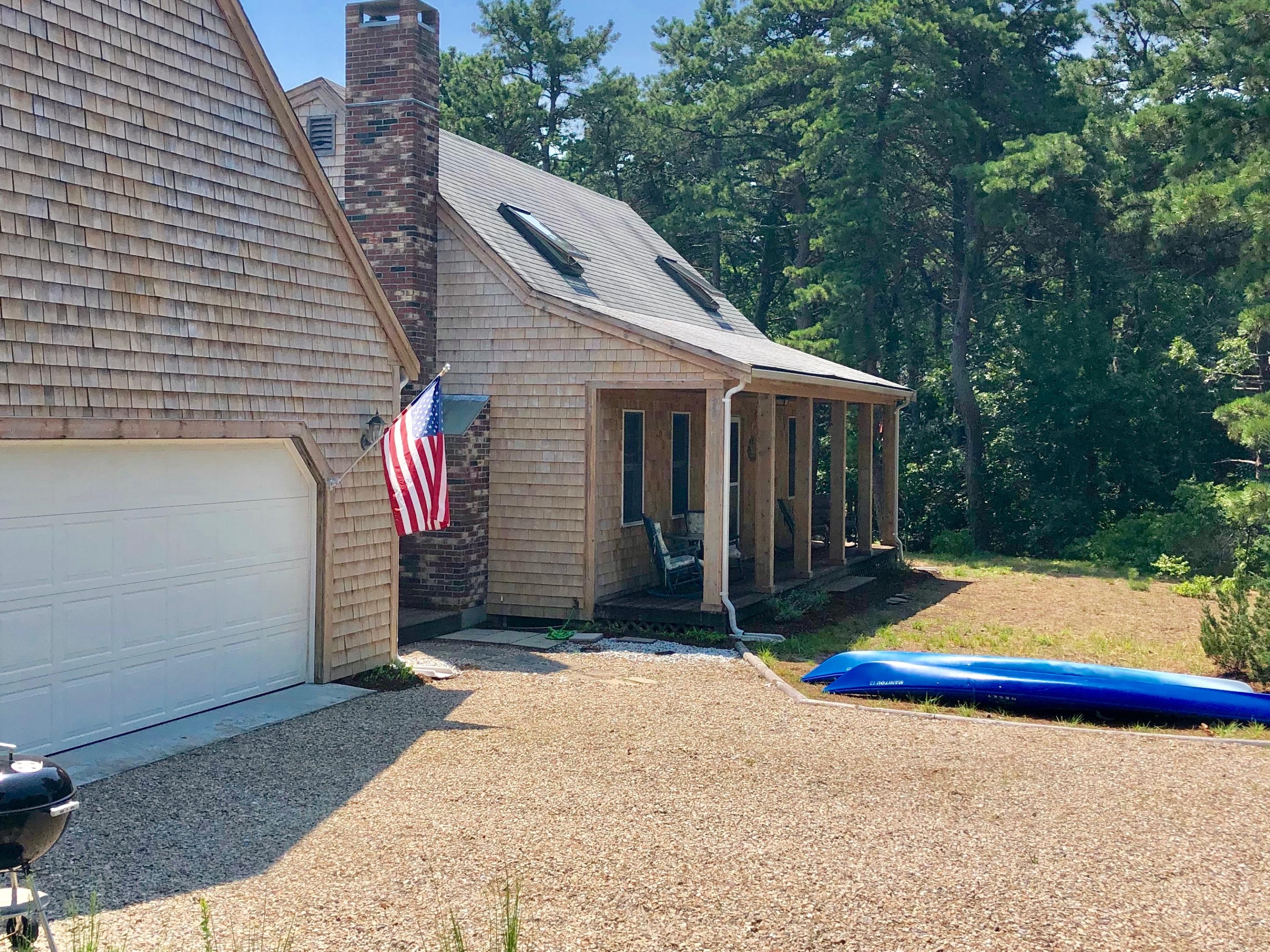 90 Jennie Clark Road Eastham, MA 02642 - Photo 31 of 35 a front view of house with yard and outdoor seating