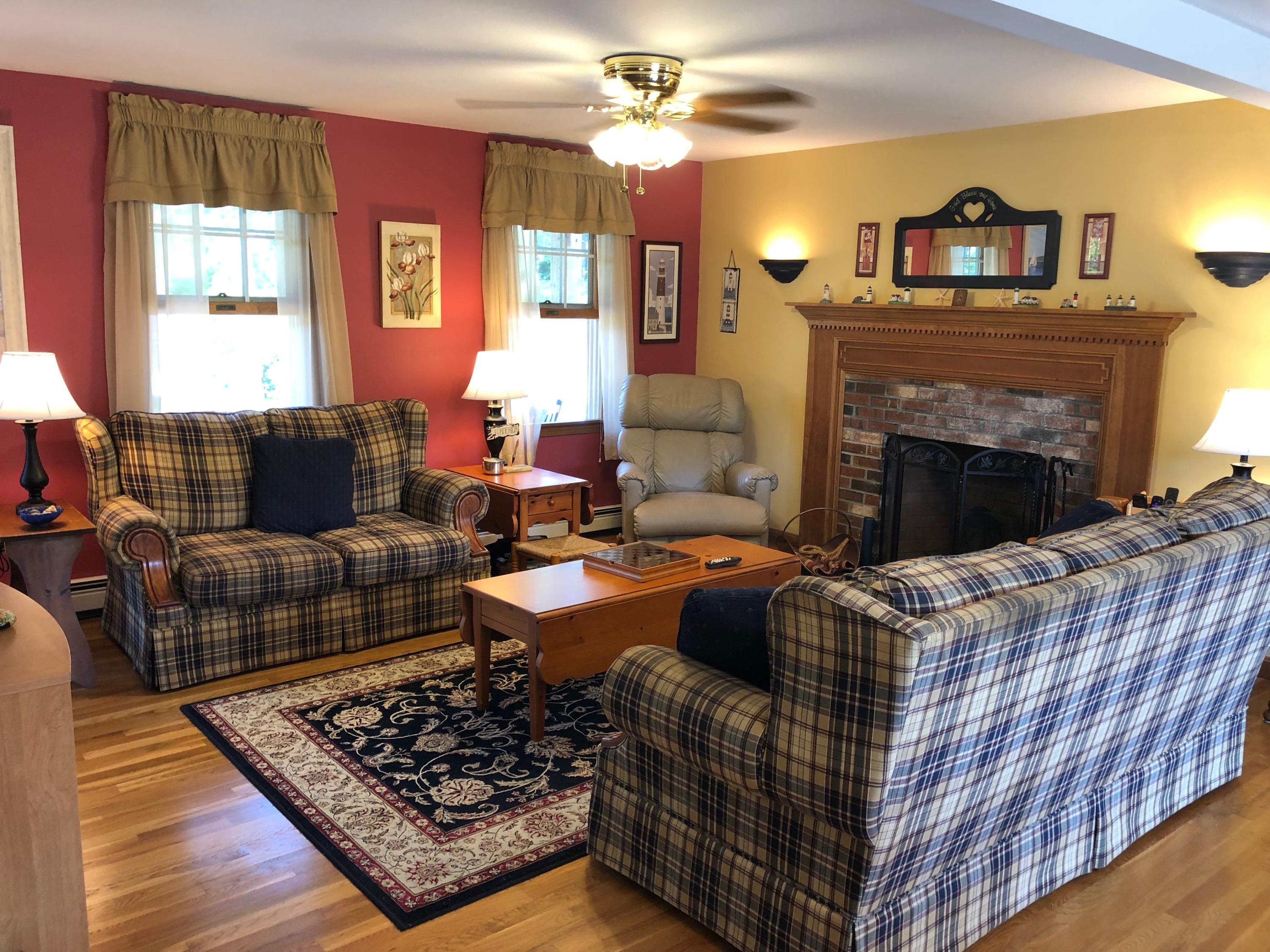 90 Jennie Clark Road Eastham, MA 02642 - Photo 7 of 35 a living room with furniture and a fireplace