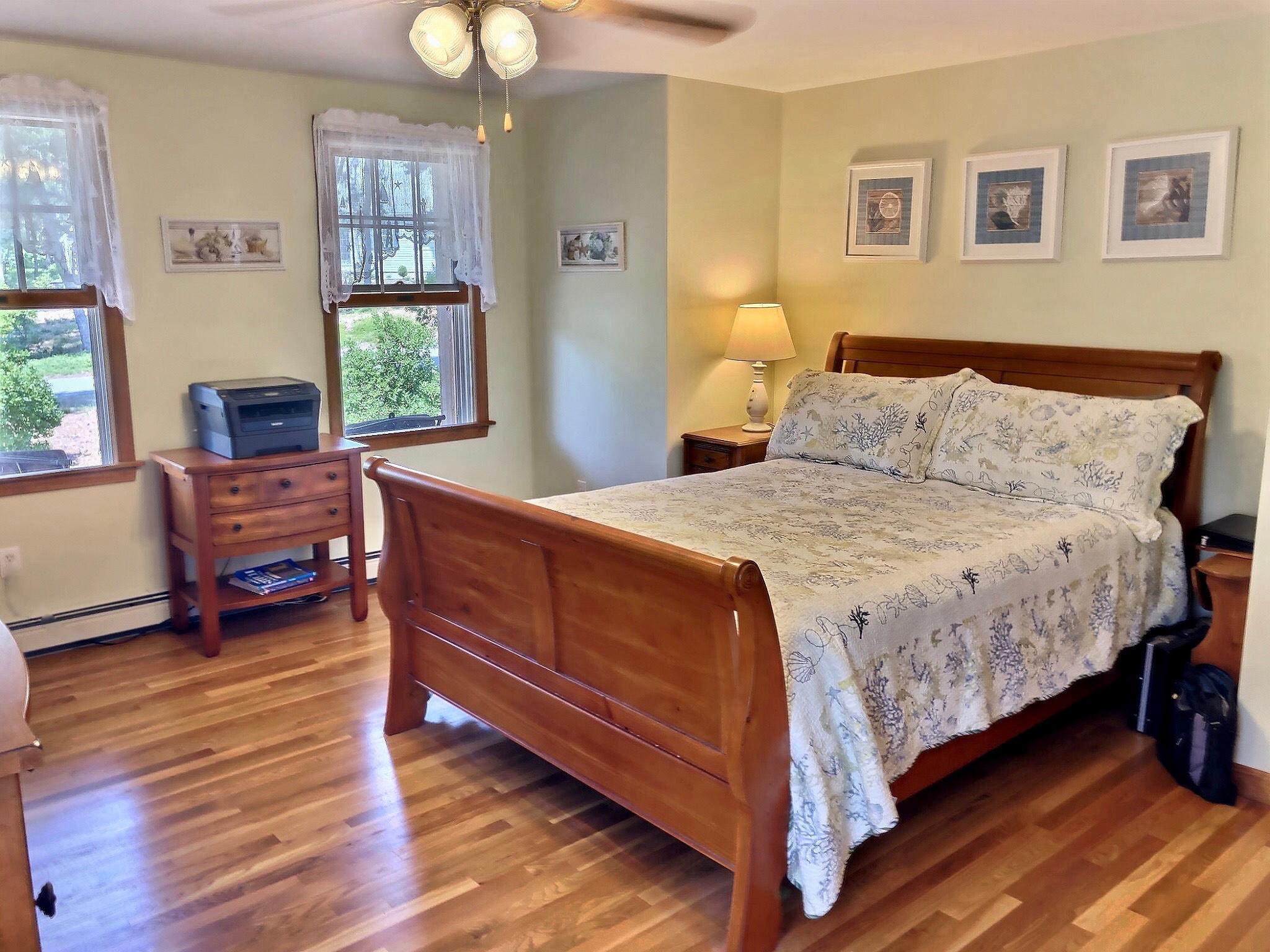 90 Jennie Clark Road Eastham, MA 02642 - Photo 8 of 35 a bedroom with a bed and wooden floor