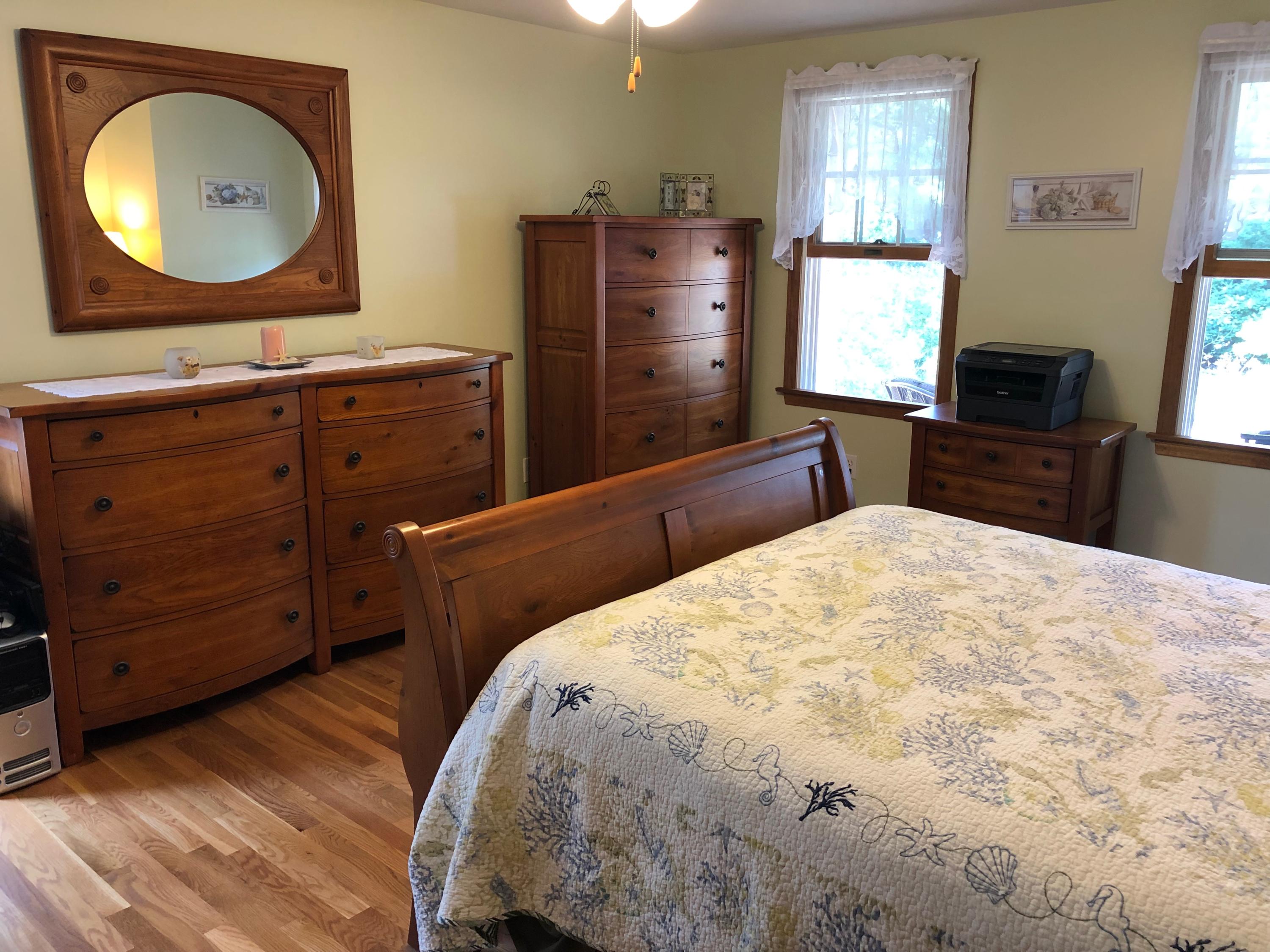 90 Jennie Clark Road Eastham, MA 02642 - Photo 9 of 35 a bedroom with a bed and a flat tv screen on dresser