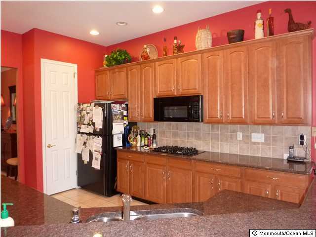 7 Crooked Stick Road Jackson, NJ 08527 - Photo 3 of 3 a kitchen with stainless steel appliances granite countertop a refrigerator and a sink