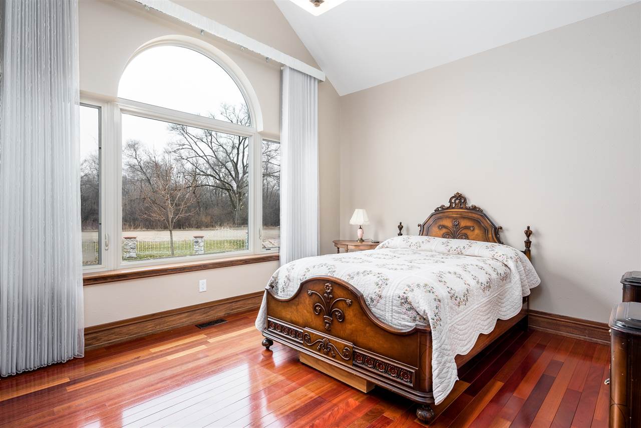 5510 Manchester Road South Beloit, IL 61080 - Photo 8 of 25 a bed sitting in a bedroom next to a window