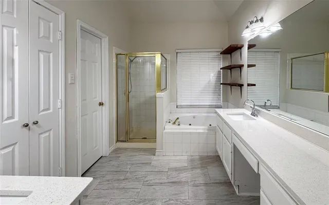 a spacious bathroom with a double vanity sink a mirror and a shower