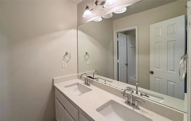 a bathroom with a sink vanity granite and a mirror