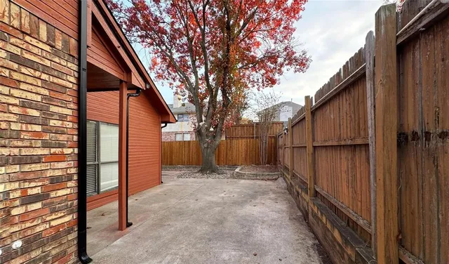 a view of backyard with small cabin and wooden fence
