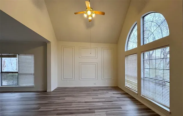 wooden floor in an empty room with a window