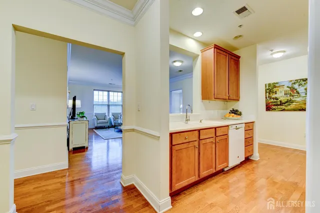 a spacious bathroom with a double vanity sink a mirror and a bathtub