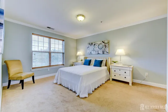 a spacious bedroom with a bed and a chair