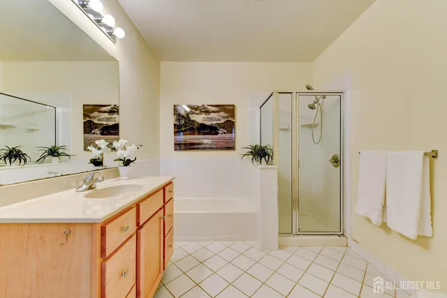 a spacious bathroom with a shower sink and mirror