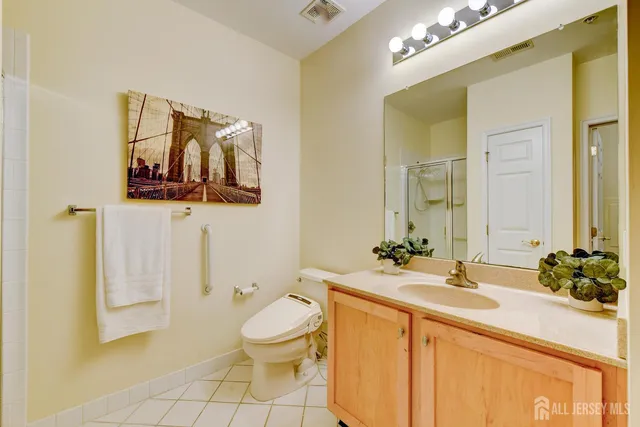 a bathroom with a toilet a sink and mirror