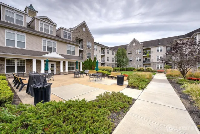 a view of a building with garden and sitting area