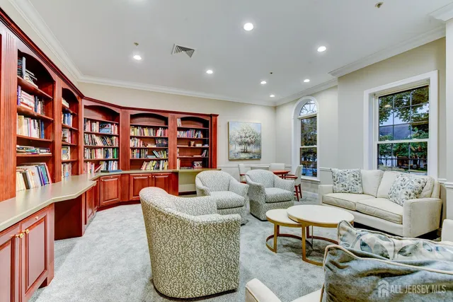 a living room with furniture and a book shelf