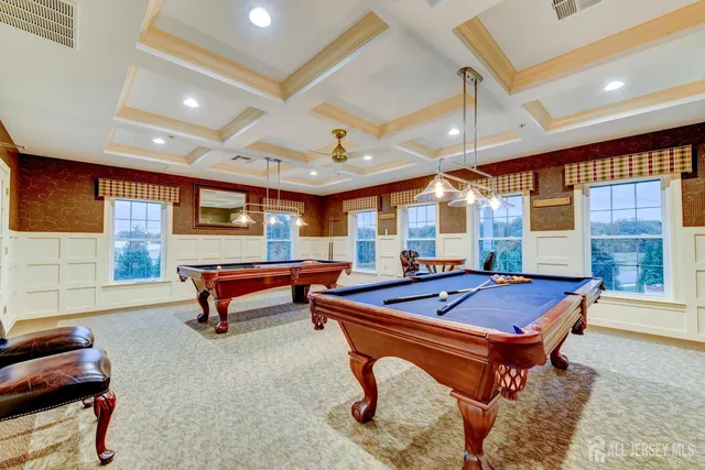 a living room with furniture a table and wooden floor