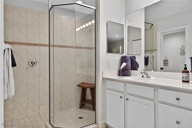 a bathroom with a shower sink and mirror