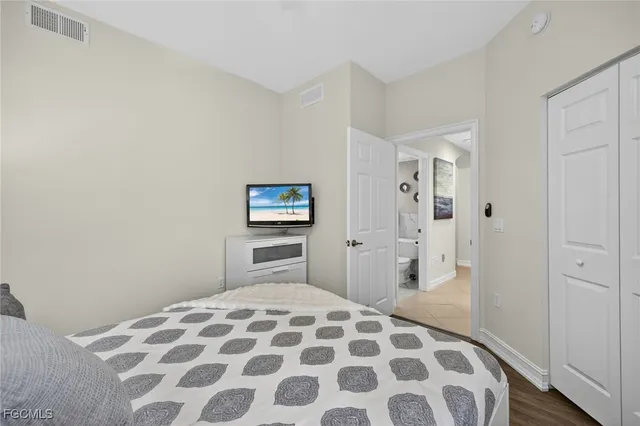 a bedroom with a bed and a lamp