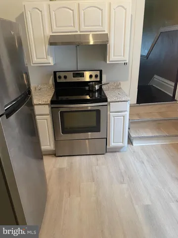 a kitchen with granite countertop a stove and a sink