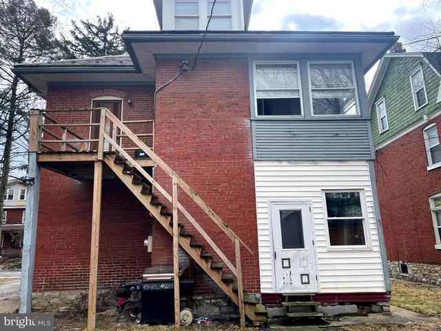 a view of a house with wooden stairs