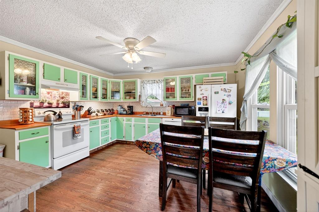610 Crooked Creek Road Edgewood, TX 75117 - Photo 15 of 33 a kitchen with a table chairs and a ceiling fan