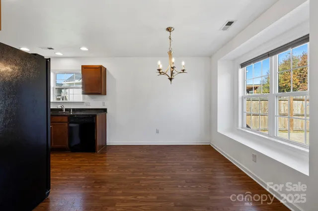 a view of kitchen with stove and refrigerator