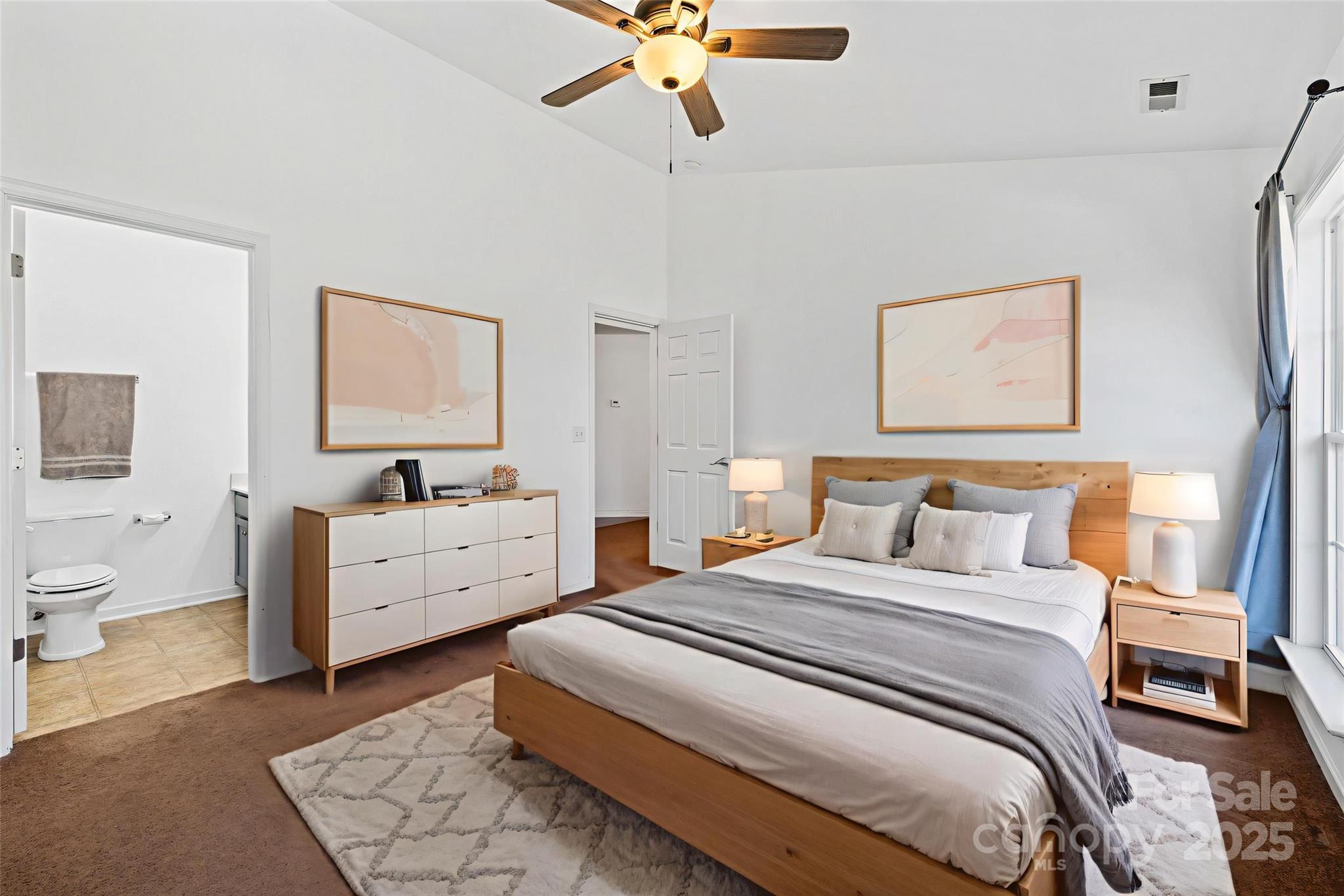 284 Mud Creek Road Fletcher, NC 28732 - Photo 14 of 31 a room with a bed and a chandelier