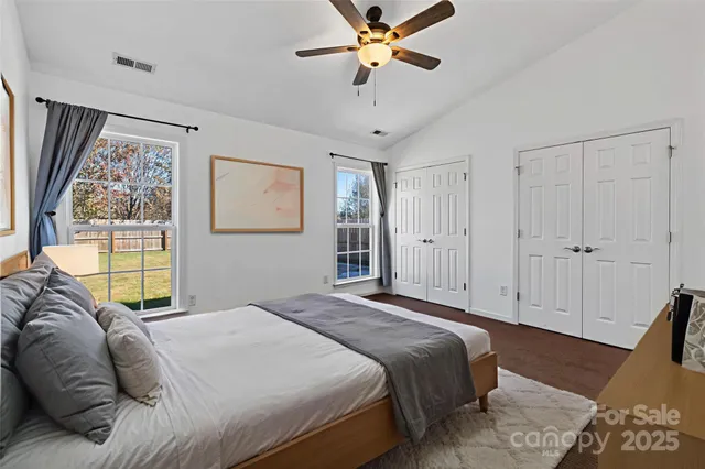 a bedroom with a bed and a painting on the wall