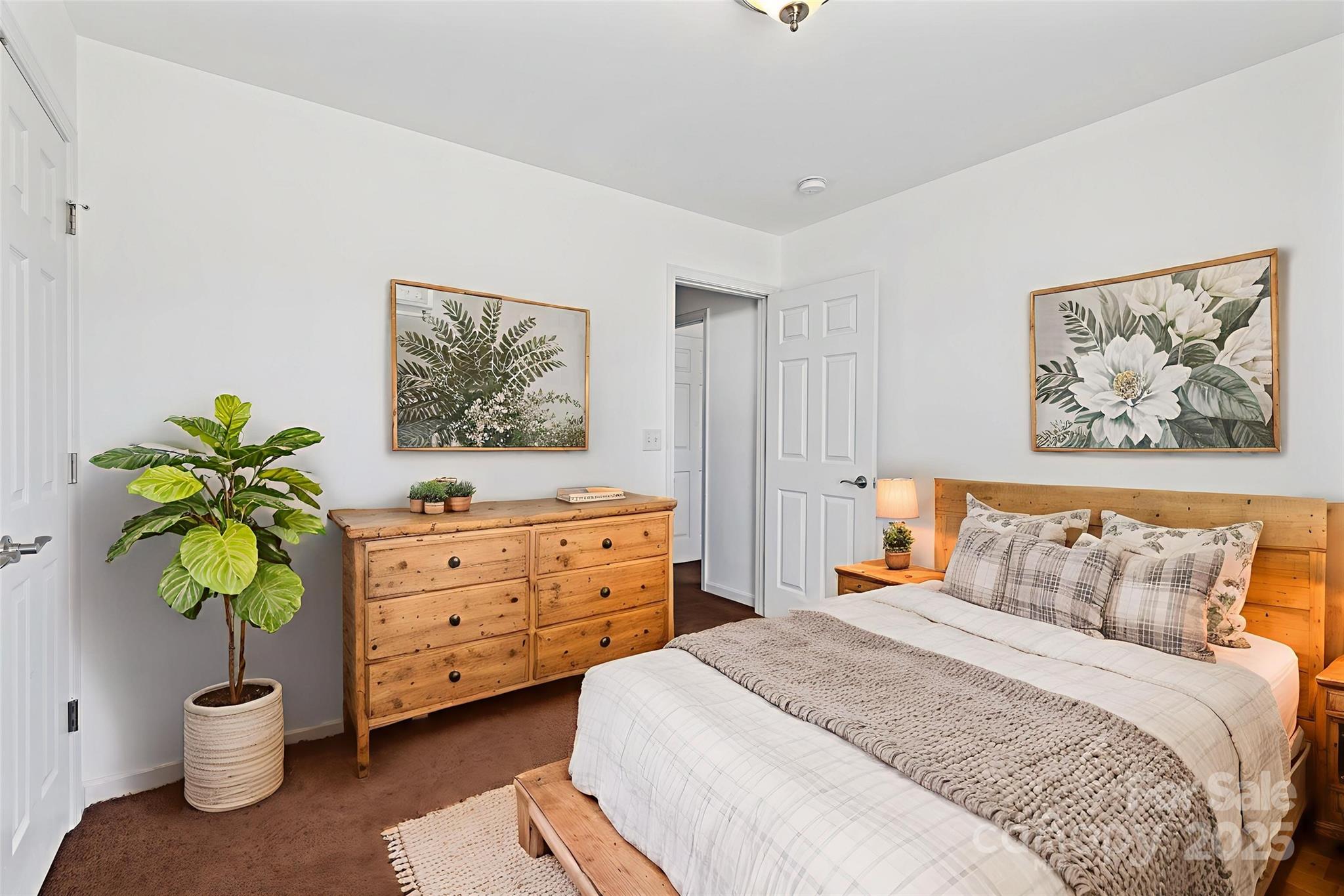 284 Mud Creek Road Fletcher, NC 28732 - Photo 19 of 31 a bedroom with a bed and a painting on the wall