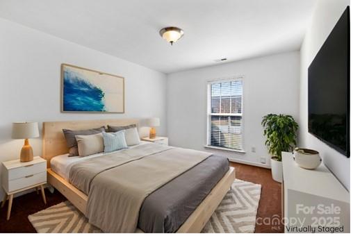 284 Mud Creek Road Fletcher, NC 28732 - Photo 20 of 36 a bedroom with a large bed and a potted plant