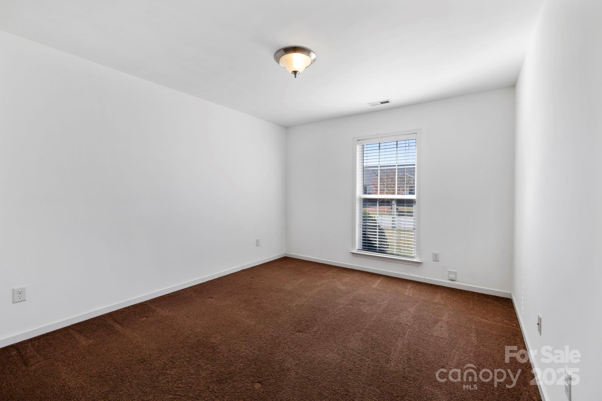 284 Mud Creek Road Fletcher, NC 28732 - Photo 21 of 36 a view of an empty room with a window