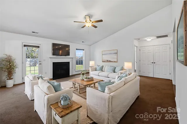 a living room with furniture fireplace and a flat screen tv