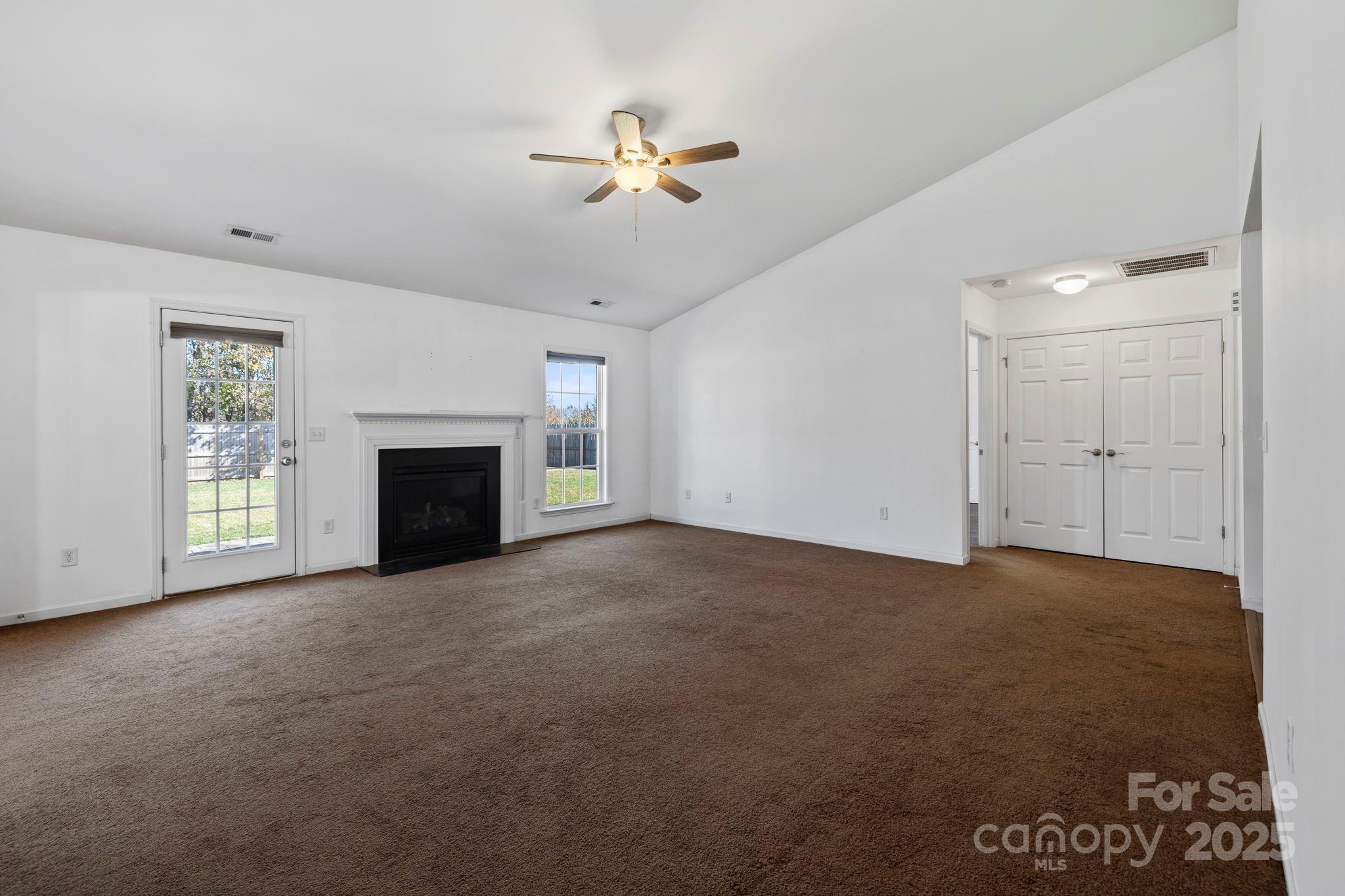 284 Mud Creek Road Fletcher, NC 28732 - Photo 8 of 36 an empty room with windows and fireplace