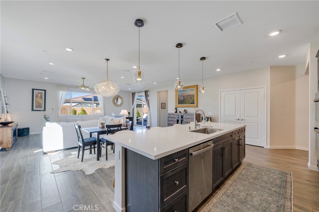 79244 Zamora Court Indio, CA 92203 - Photo 12 of 52 a large kitchen with kitchen island a sink table and chairs