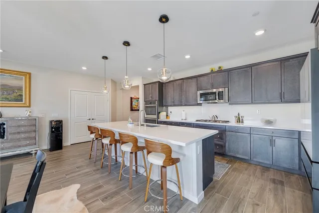 a large kitchen with lots of counter space a sink appliances and cabinets