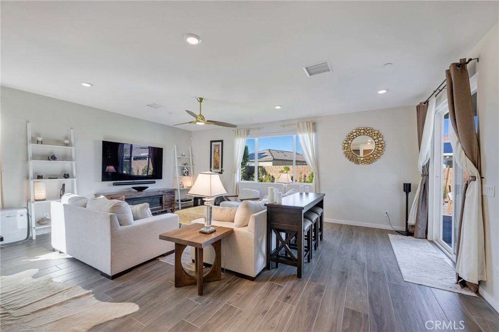 79244 Zamora Court Indio, CA 92203 - Photo 16 of 52 a living room with furniture a flat screen tv and a wooden floor