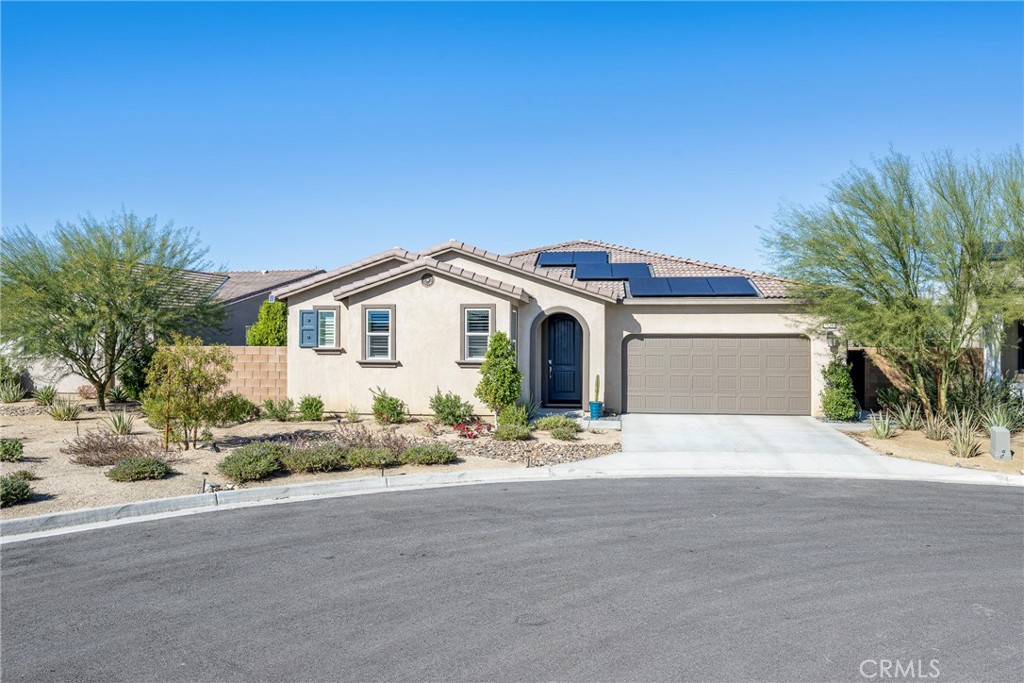 79244 Zamora Court Indio, CA 92203 - Photo 2 of 52 a front view of a house with a yard and garage