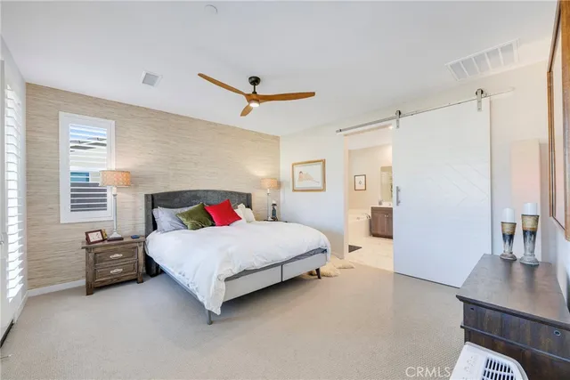 a spacious bedroom with a bed and a table