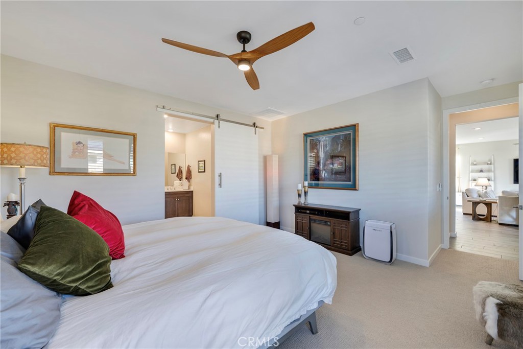 79244 Zamora Court Indio, CA 92203 - Photo 22 of 52 a bedroom with a bed and a chandelier