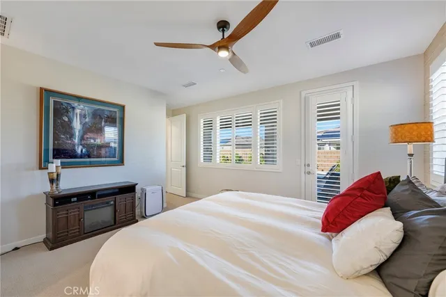 a bedroom with a bed and a painting on the wall