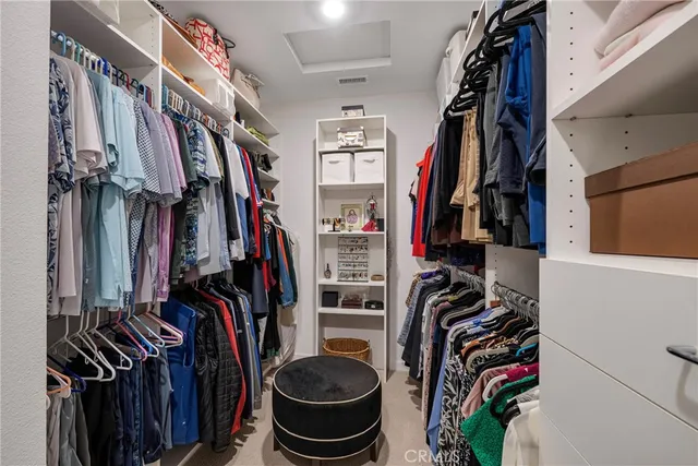 a view of walk in closet with clothes