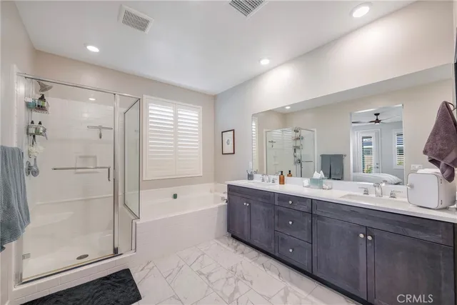 a spacious bathroom with a shower sink mirror and