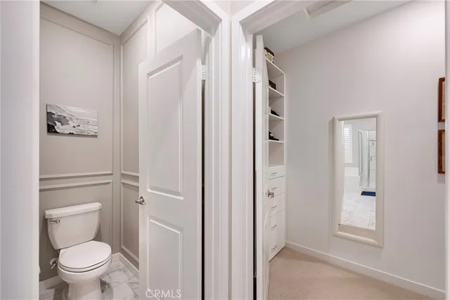 a bathroom with a granite countertop toilet a sink and shower