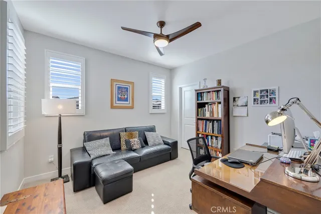 a living room with furniture and a book shelf