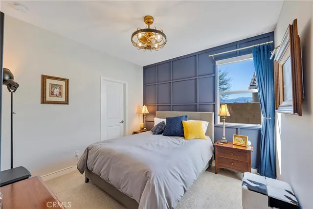 a bedroom with a bed and a painting on the wall