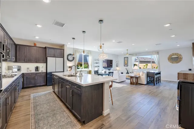 a kitchen with lots of counter top space and painting on the wall
