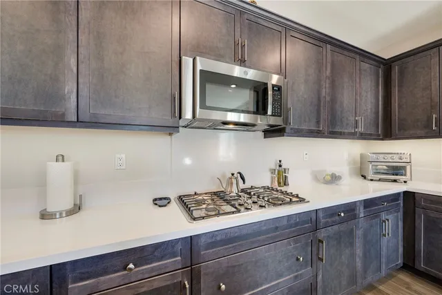 a kitchen with a sink microwave and cabinets