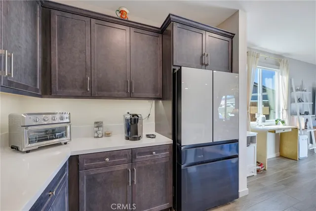 a kitchen with stainless steel appliances granite countertop a refrigerator and a sink