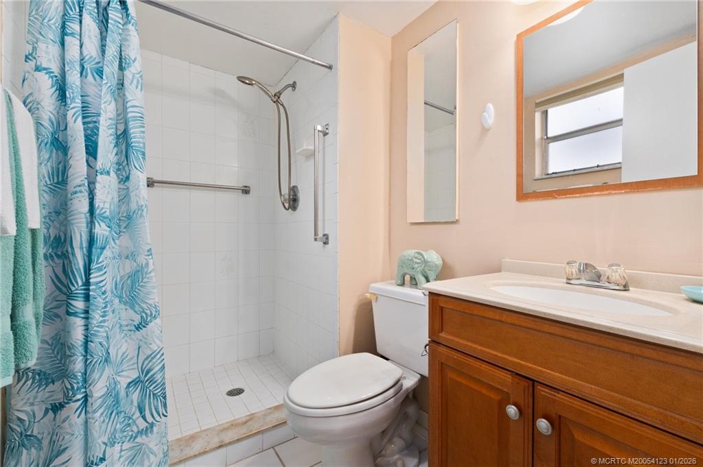 1980 Southwest Palm City Road, Unit 50J Stuart, FL 34994 - Photo 18 of 37 a bathroom with a granite countertop sink toilet and shower