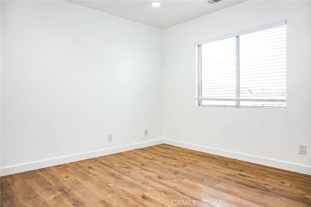 13142 Windsor Lane Garden Grove, CA 92843 - Photo 13 of 24 an empty room with wooden floor and windows