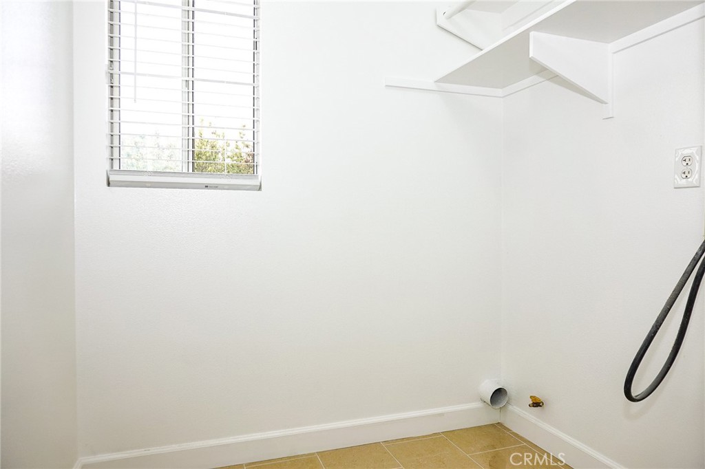13142 Windsor Lane Garden Grove, CA 92843 - Photo 15 of 24 a view of a bathroom with a window and a ceiling fan